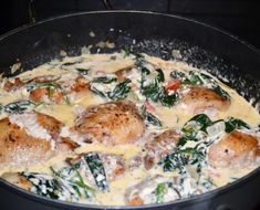 a pan filled with meat and spinach covered in cheese