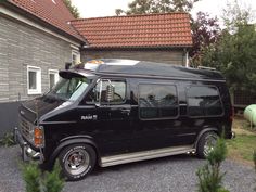 a black van parked in front of a house