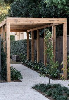 a wooden pergoline in the middle of a garden