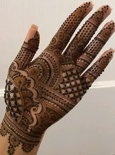 a hand with henna tattoos on it