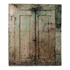 an old wooden door with peeling paint on the doors and side panels, isolated against a white background