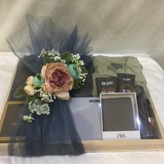 an arrangement of flowers and other items on a tray