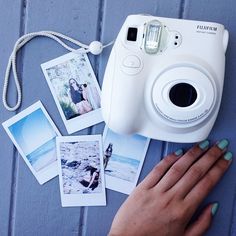 a camera and some pictures on a table