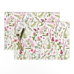 two placemats with floral designs on them, one has a pair of scissors