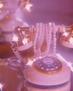 an old fashioned phone with pearls on it