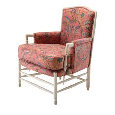 an upholstered chair with floral fabric