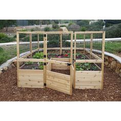 an outdoor garden with wooden planters and raised beds