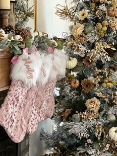 christmas stockings hanging from a tree in front of a fireplace