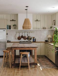 a kitchen with an island and wooden stools