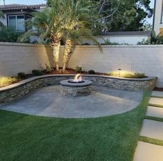 an outdoor fire pit surrounded by grass