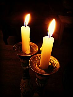 two lit candles with the words chag pesach sameach