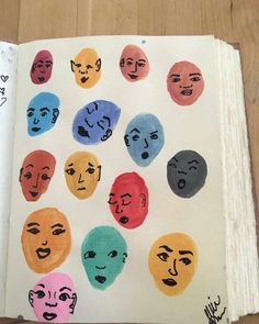 an open book with many different faces drawn on it