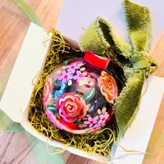 a decorated ornament in a box on a table