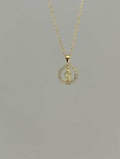 Dainty and so sparkly, our Virgin Mary pendant is simply beautiful! Information: ✨ Sterling Silver (925 stamped) | 14K Gold ✨ AAAA+ Cubic Zirconia Gemstones ✨ Adjustable Length: 16" - 18" ✨ Charm size: 1/2" by 1/2" ✨ Hypoallergenic ✨ Tarnish Resistant Our Virgin Mary necklace is made with high quality materials, including Sterling Silver, 14K Gold and Cubic Zirconia. Every part of the pendant shows a high grade of craftsmanship and attention to detail. At the center of the charm, we placed the image of the Virgin Mary surrounded by Zirconia diamonds in a halo style - they are very sparkly! Our necklace is adjustable, you can wear it at 16", 17" and 18" allowing you to find your perfect fit. Plus, it's a perfect everyday piece. This necklace can be worn by itself for a minimalist look or yo Gold Virgin Mary Necklace, Virgin Mary Pendant, Mary Necklace, Virgin Mary Necklace, Necklace Christian, Halo Style, Virgin Mary, Simply Beautiful, Halo Diamond