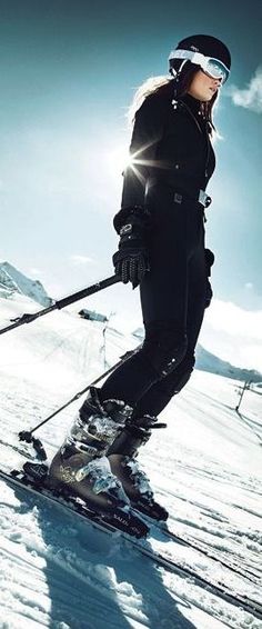 a woman riding skis down a snow covered slope