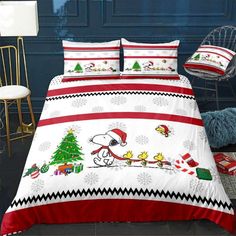 a bed room with a christmas themed comforter and pillows