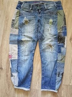 an old pair of jeans with patches on them