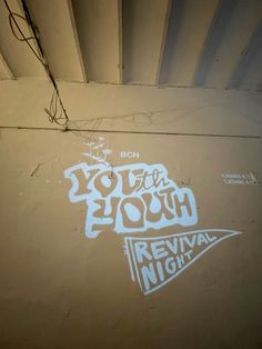 graffiti on the side of a building that says youth youth revival night written in white