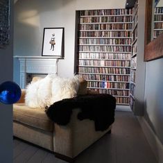 a living room filled with furniture and lots of books