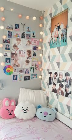 a bed room with a neatly made bed and posters on the wall