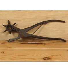 an old pair of pliers on a wooden surface