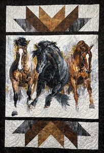 three horses running in the same direction on a black and white quilted wall hanging