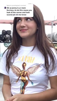 a woman wearing a t - shirt with an angel on it