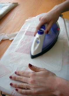 a woman ironing fabric with an electric iron