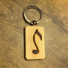 a wooden keychain with a musical note on it