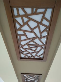 the ceiling in this room is made out of wood and has decorative designs on it