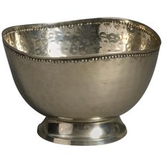 a large silver bowl sitting on top of a metal stand