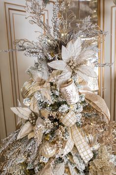 a christmas tree with gold and silver decorations