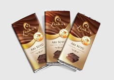 three chocolate bar wrappers with the word aru sutu written on them in gold lettering