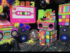 colorful party decorations with boomboxs, balloons and streamers