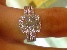 a woman's hand with a diamond ring on it