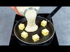 someone is using a whisk to stir butter on a pan with cubes