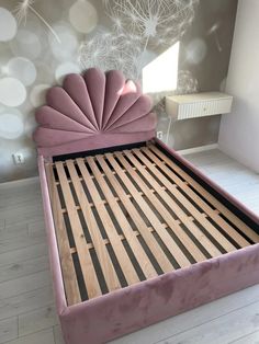 a pink bed with an intricate headboard and foot board