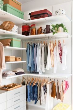 an organized closet with white shelves and clothes hanging on the hooks, shoes and other items