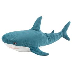 a stuffed shark is shown on a white background