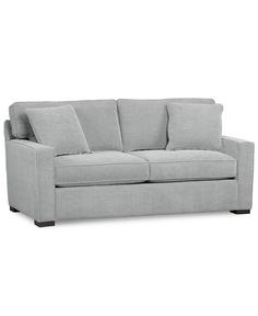 a light gray couch with pillows on it