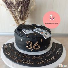 a birthday cake with money on top and the number 35 written on it in gold