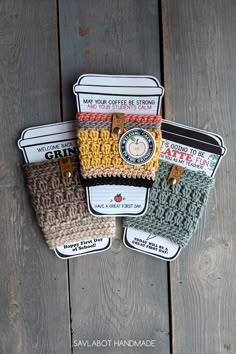 three small crocheted bags sitting on top of a wooden table next to each other