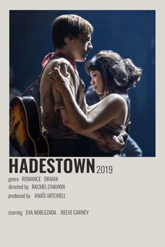 a man and woman embracing each other in front of a microphone with the words hadestown written on it