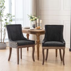 two chairs sitting next to each other on top of a hard wood floor