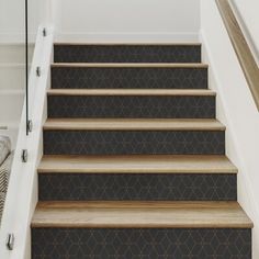 the stairs are lined with black and brown carpet