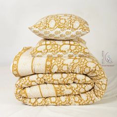 a stack of pillows sitting on top of each other in front of a white background