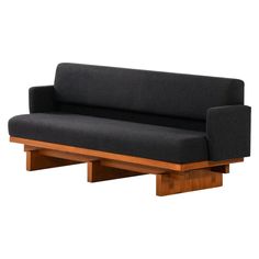 a black couch sitting on top of a wooden frame