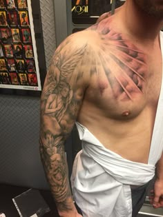 a man with tattoos on his chest and arm