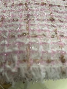 the fabric is covered with white and pink flecks on it's edges