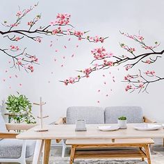 a living room filled with furniture and a large painting on the wall above a table